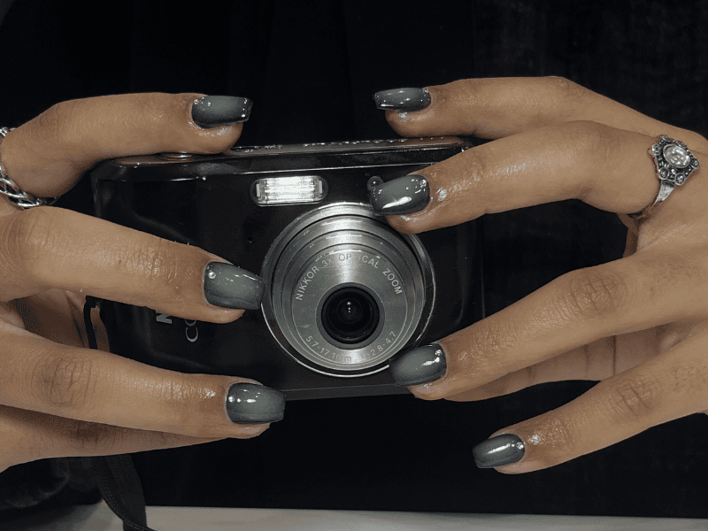 Riri Nails Oman acrylic nail service featuring elegant dark theme nail designs