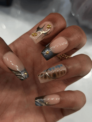 Stylish GelX nail extension with golden flame design by Riri Nails in Muscat Oman