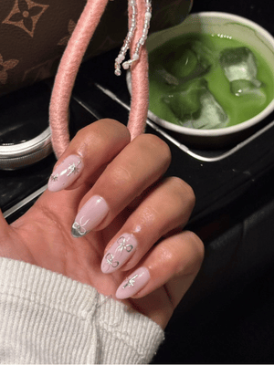 GelX nail extension with silver bow and star design by Riri Nails Oman at Muscat