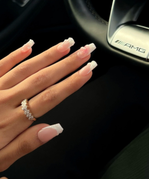 Riri Nails GelX extension manicure in Muscat Oman with elegant pink nude nails and AMG steering wheel background.