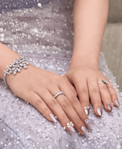 Gel X nail extension with lavender floral shimmer nail art design by Riri Nails salon in Muscat, Oman.